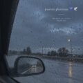 Femme conductrice souriante au volant par temps de pluie sur une route mouillée.