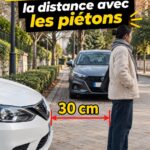 Femme conduisant dans un environnement urbain, en évaluant la distance avec un piéton